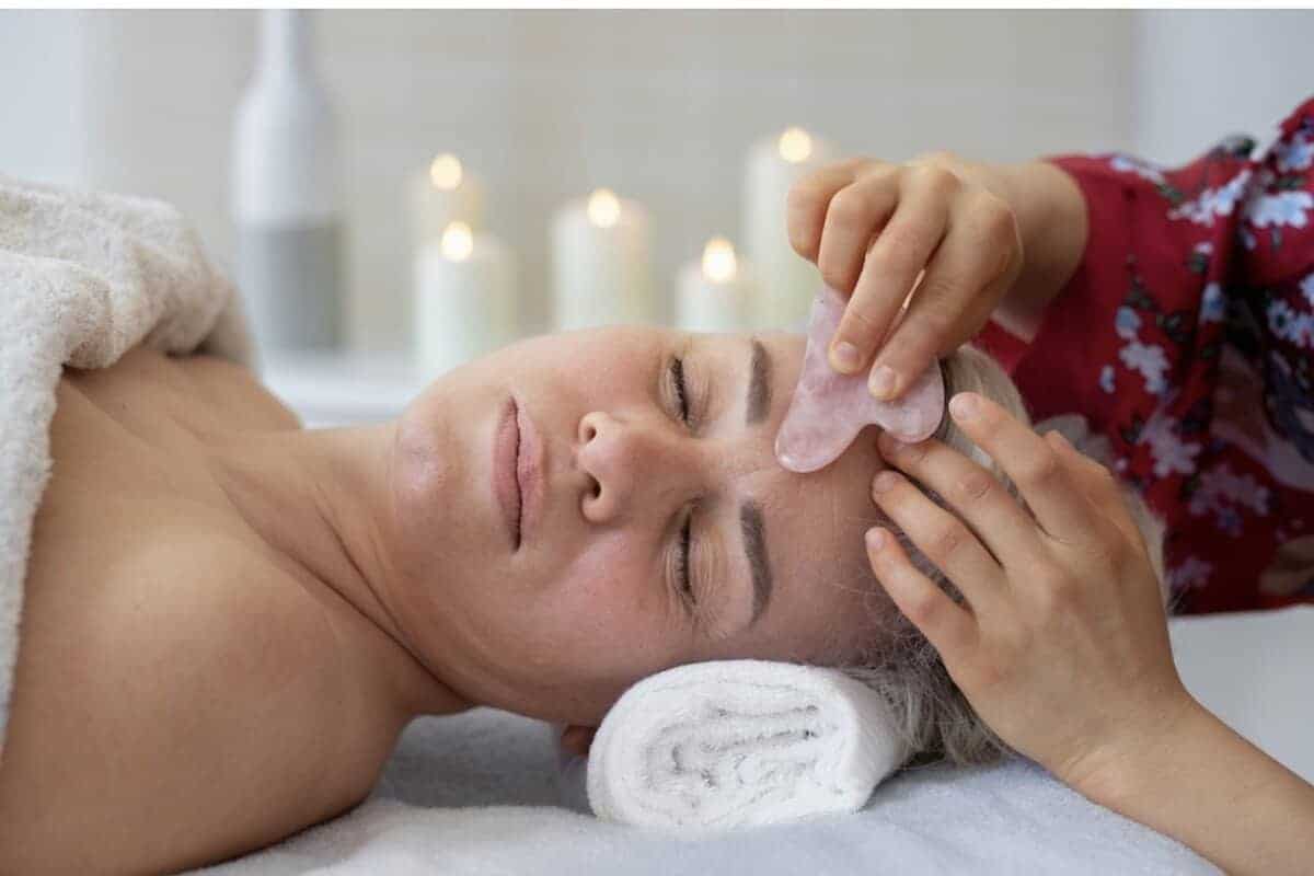 A woman getting a facial treatment at a spa.