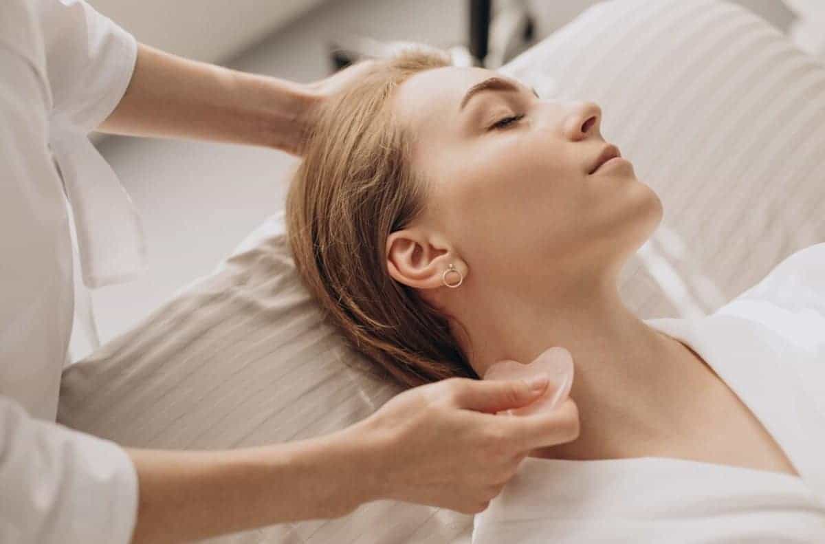 A woman is getting a massage on her neck.